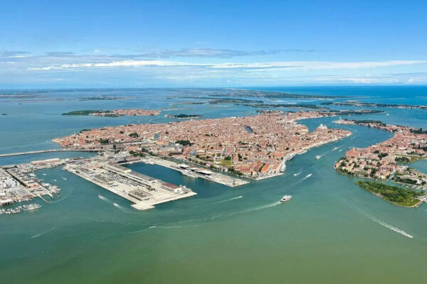 Which famous city is made up of 118 small islands in Italy and attracts millions of visitors each year |