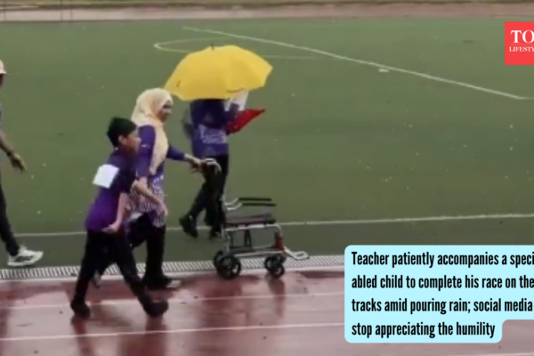Teacher patiently accompanies a specially abled child to complete his race on the tracks amid pouring rain; social media can't stop appreciating the humility |