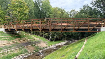 More than a century ago, a railroad dam blocked Michigan’s Buckhorn Creek; after its removal, the stream is flowing freely again and a new 90-foot bridge now crosses above it