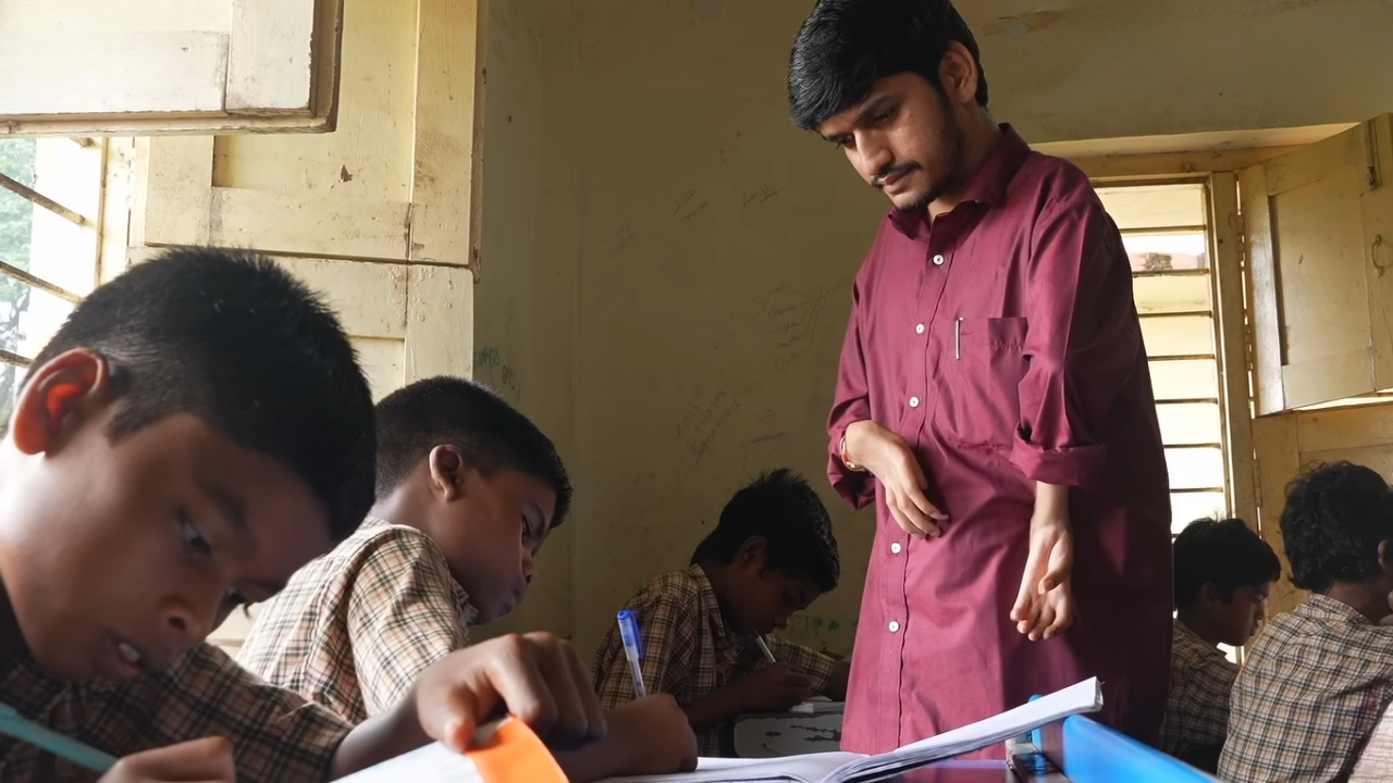 Simhachalam Naidu was born with disability in both hands; today, he is a government school teacher who writes with his legs: “To move forward in life, I had to accept that my feet were my hands”