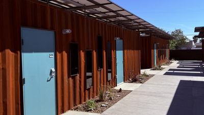 Phoenix turned shipping containers into 40 private transitional homes for homeless seniors; each 160-sq-ft unit has a bathroom, and 56 permanent apartments are planned next